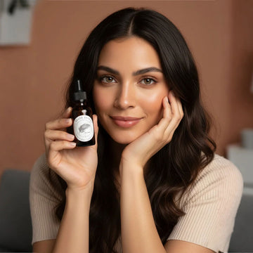 Woman holding a skincare bottle with a blurred background
