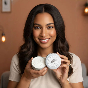Woman holding two jars of a skincare product with a neutral background